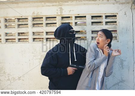 Thief Armed Man Rob Woman By Gun On Street So Scared Shocked Face. Frightened Asian Woman Was Rob Ag