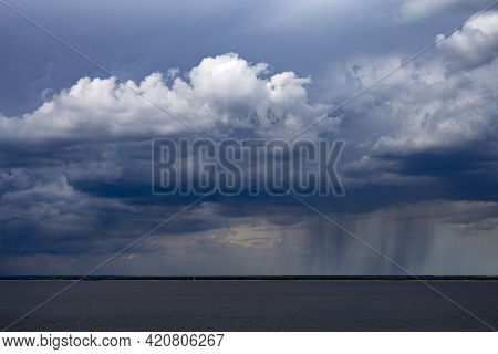 Rainy Clouds Over The River. Dark Cloud In Rainy Weather Over The River. Storm Clouds Over Horizon. 