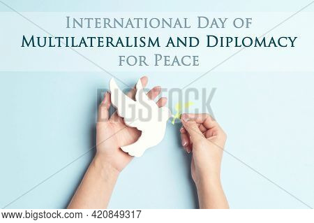 International Day Of Multilateralism And Diplomacy For Peace,april 24. Female Hands Hold Dove Of Pea