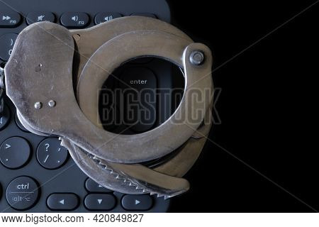 Handcuffs On The Keyboard On A Black Background - Freedom Of Speech On The Internet