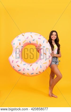 Happy Beach Teen Girl With Donut Inflatable Ring For Pool Party Fun On Summer Vacation, Summertime.