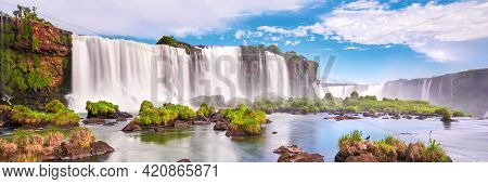 Majestic Iguazu Waterfalls In Argentina. Panoramic View Of Many Majestic Powerful Water Cascades Wit