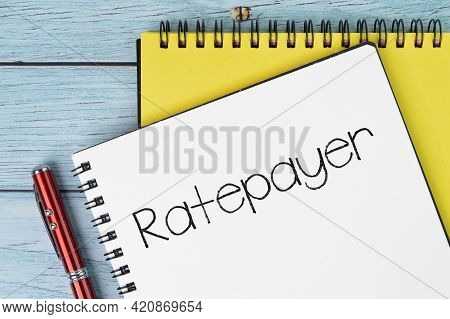 Top View Of Pen And Notebooks Written With Ratepayer. Business Concept.