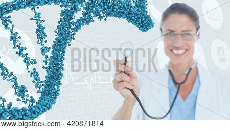 Composition of dna strand over caucasian female doctor smiling and digital interface. global medicine and digital interface concept digitally generated image.