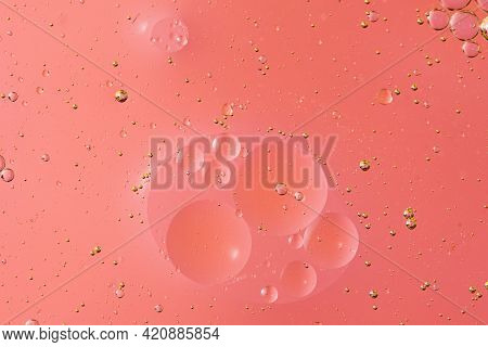 Oil With Bubbles On Light Pink Coral Monochrome Background. Abstract Space Background. Soft Selectiv