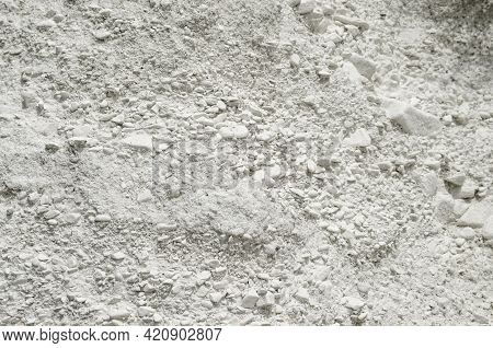 Natural Chalk Mineral Background. Small Smooth Calcite Stones Are Mixed With Chalk Clay. Calcium In