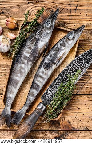 Raw Mackerel Icefish In A Wooden Tray. Wooden Background. Top View