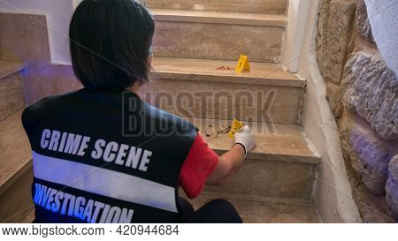 Csi Crime Scene Forensic Investigator On Internal Stairs Examining Evidence