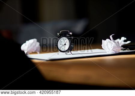 Modern Workplace, Wooden Office Desk In Hardlight, Sunligt With Clock, Sheet Of Paper
