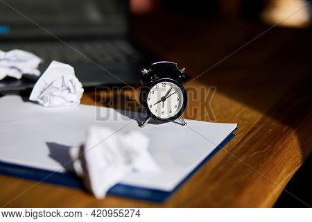 Modern Workplace, Wooden Office Desk In Hardlight, Sunligt With Clock, Sheet Of Paper