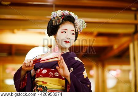 Kyoto, Japan - 18 May, 2015: Maiko Apprentice Showing Japanese Traditional Dance. Maiko Is An Appren