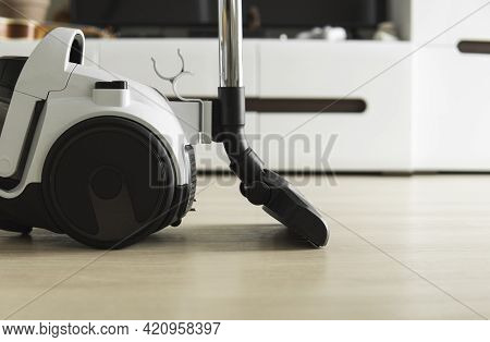 Bagless Cyclone Vacuum Cleaner On A Laminate. Electrical Apparatus That By Means Of Suction Collects
