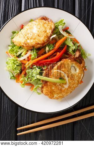 Yam Khai Dao Fried Egg Spicy Salad With Vegetables And Herbs Is A Thai Dish Close Up In The Plate On