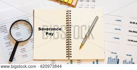 Severance Pay On White Blank Notepad With Financial Papers