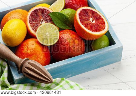 Various fresh citrus fruits in wooden box. Bood orange, lime, lemon