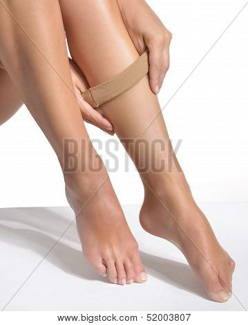 woman putting on stockings