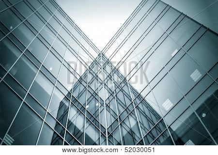 Panoramic and perspective wide angle view to steel blue background of glass high rise building skyscrapers in modern futuristic downtown at night Business concept of successful industrial architecture