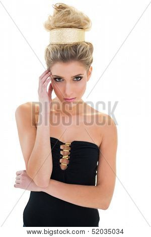 Pensive attractive blonde model with big hairstyle looking at camera on white background
