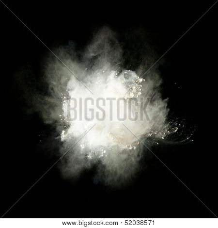 Freeze motion of white dust explosion isolated on black background
