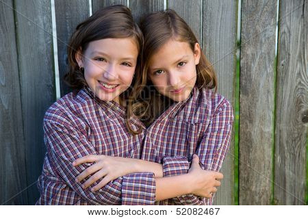 twin girls fancy dressed up pretending be siamese with his father shirt