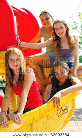 Portrait of a group of four young girls on a school playground