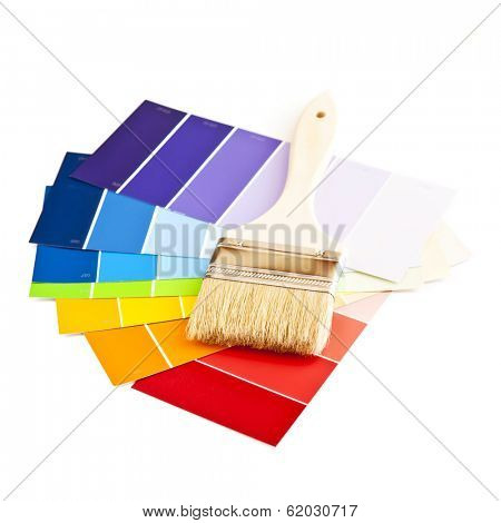 Clean paintbrush on rainbow of color card samples