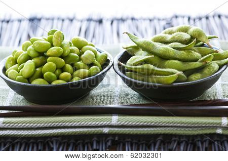 Edamame soy beans shelled and with pods in bowls