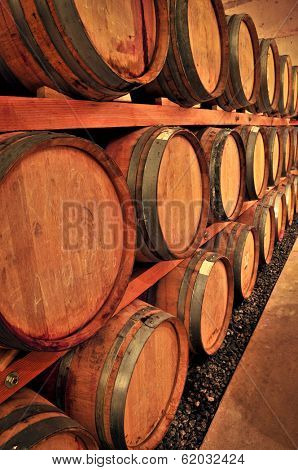 Stacked oak wine barrels in winery cellar