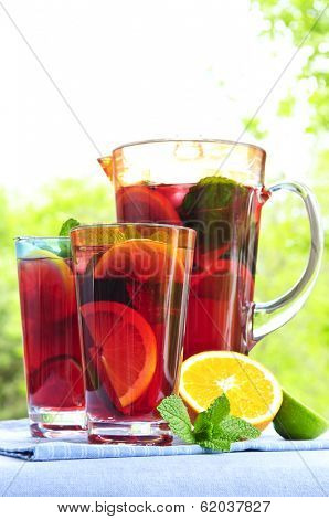 Refreshing fruit punch beverage in pitcher and glasses