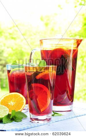 Refreshing fruit punch beverage in pitcher and glasses