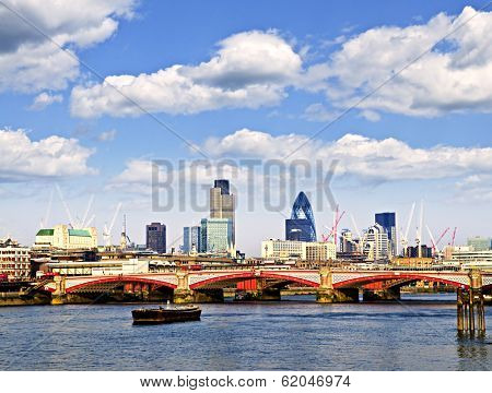 Blackfriars Bridge with London skyline behind from Thames river