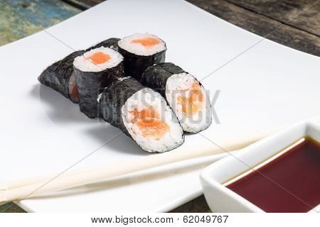 Makisushi On White Plate. Seafood Traditional Maki Sushi Rolls With Chopsticks