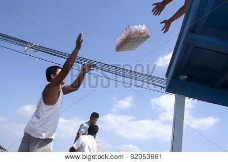 Man Is Loading The Ferry By Throwing Goods