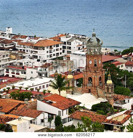 Cityscape view from above with church and Pacific ocean in Puerto Vallarta, Mexico