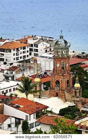 Cityscape view from above with church and Pacific ocean in Puerto Vallarta, Mexico