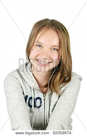 Isolated portrait of beautiful teenage girl listening to earphones
