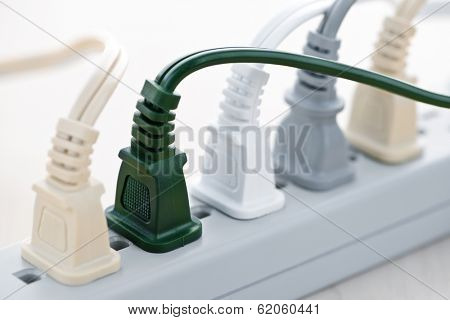 Many wires plugged into electric power bar