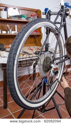 Real bicycle mechanic repairing custom fixie bike