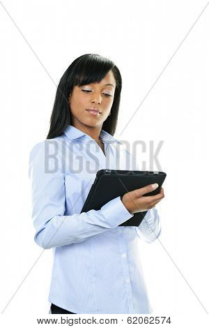 Young serious black woman working with tablet computer