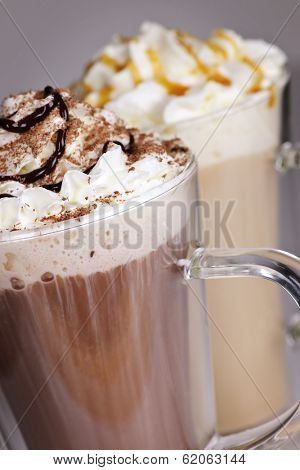 Hot chocolate and coffee latte beverages with whipped cream