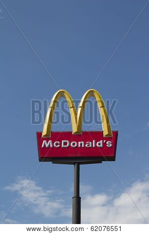 JACKSONVILLE, FL - MARCH 8, 2014: McDonalds logo on blue sky background in Jacksonville. It is the world's largest fast food chain, over 31,000 restaurants worldwide, serve 58 million customers a day.