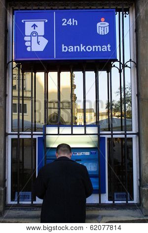 KRAKOW, POLAND, 25 OCTOBER 2003 -- A customer withdraws money from a Bank PKO BP automated teller cash machine. Bank PKO is one of Poland's leading financial institutions.