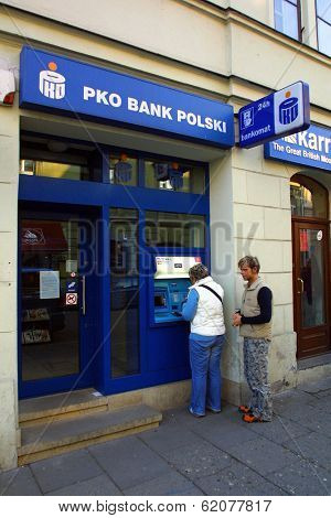KRAKOW, POLAND, 25 OCTOBER 2003 -- A customer withdraws money from a Bank PKO BP automated teller cash machine. Bank PKO is one of Poland's leading financial institutions.