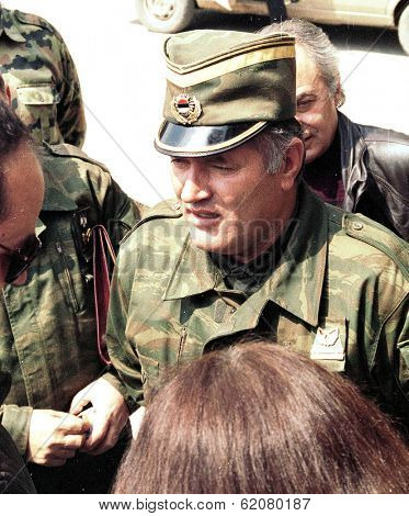 PALE, BOSNIA - APR 11: Reporters cluster around Bosnian Serb general Ratko Mladic as he speaks before attending church services in Pale, Bosnia, on Sunday, April 11, 1993.