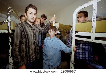 GYOR, HUNGARY - OCTOBER 14: Kosovar Albanian refugees crowd a Hungarian border police detention center west of Budapest.  Adnon Berisha, age 12, right, said he wants to join his family in Germany on October 14, 1998 in Gyor, Hungary