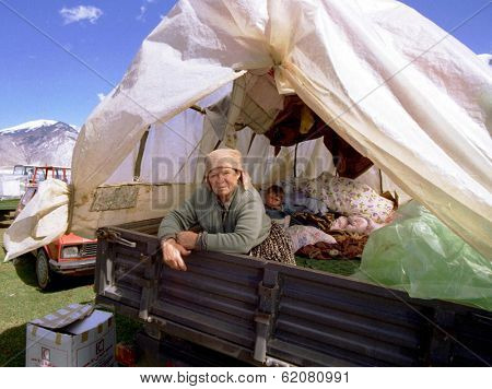 KUKES, ALBANIA - APRIL 17: A grandmother and her grandson share a crowded tractor cart at a refugee camp along the Kosovo border on April 17, 1999 in Kukes, Albania