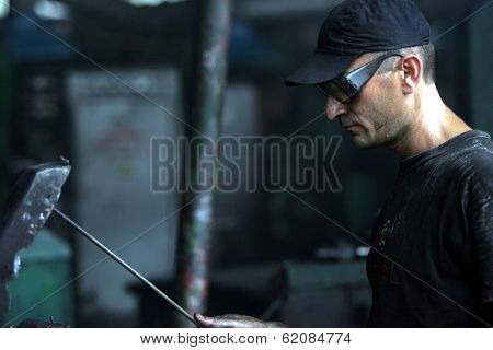DONETSK - JULY 13: Steel workers create linked chain at the CJSC Vistec steelworks in Donetsk, Ukraine,  on Thursday, July 13, 2006.