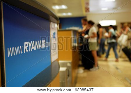 GERONA - October 21: Passengers line up at a check-in desk for Ryanair, the low budget carrier at Gerona, Spain, on October 21, 2005.