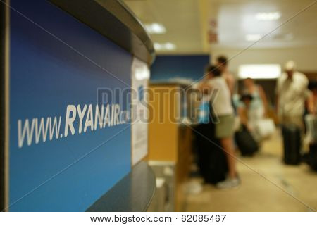 GERONA - October 21: Passengers line up at a check-in desk for Ryanair, the low budget carrier at Gerona, Spain, on October 21, 2005.