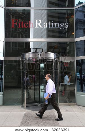 NEW YORK CITY - JULY 11: Pedestrians walk past the headquarters of Fitch Ratings in lower Manhattan on Thursday, July 11, 2013. Fitch Group is a jointly owned by Hearst Corporation and FIMALAC SA